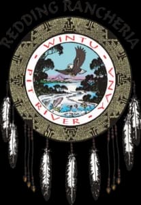 Circular seal featuring "Redding Rancheria" text with Native American imagery and decorative feathers.